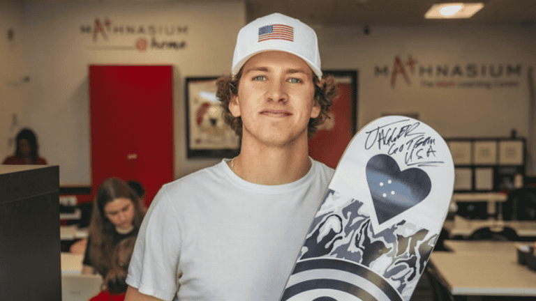 Jagger Eaton holding signed skate board. Mathnasium on Chise Franchise News