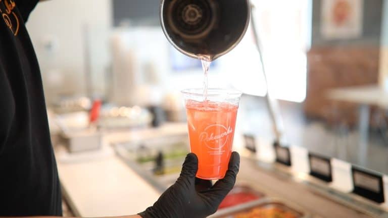 Pokeworks employee pouring beverage