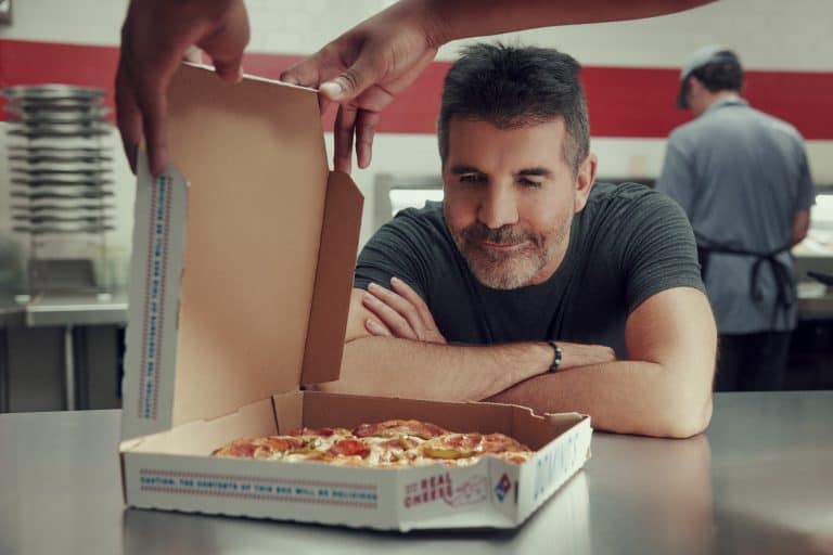 Simon Cowell judging pizza for perfection