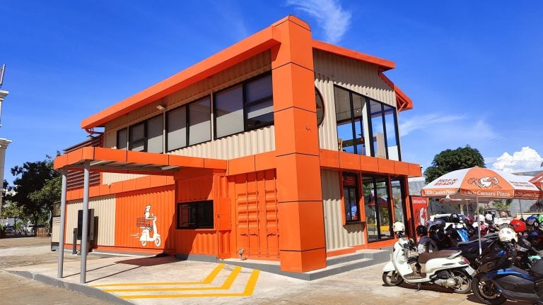 Image of restaurant. Orange building in Little Caesars colors. Representing the First restaurant in Koh Pich and Phnom Penh Cambodia