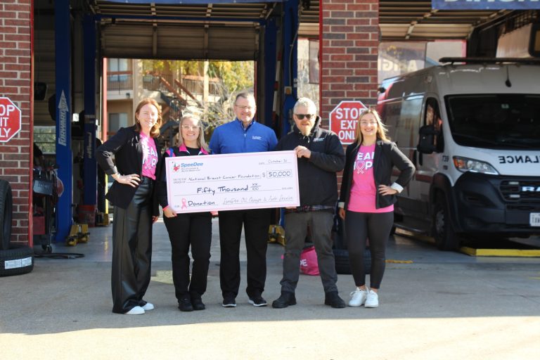 5 people presenting a check to the National Breast Cancer Foundation