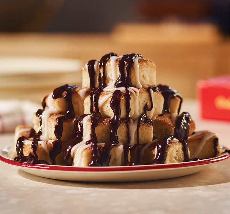 Image of Marcos Pizza New Chocolate Cinna Squares stacked 4 high on plate.