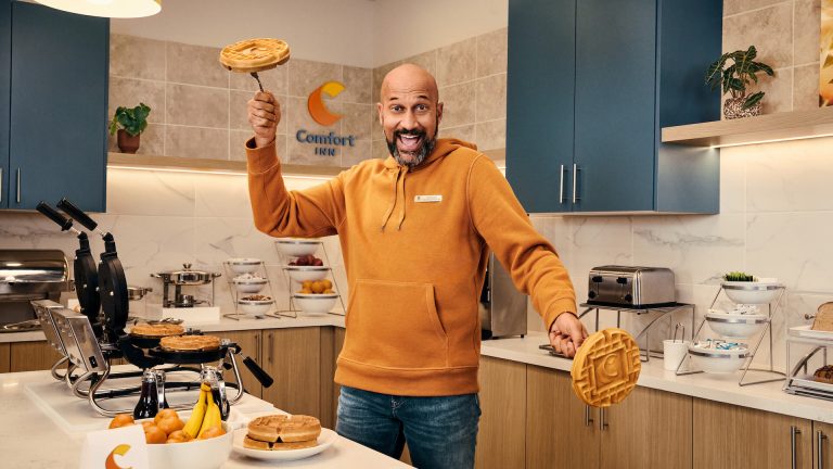 Keegan-Michael Key holding waffles with a funny look in a choice hotel