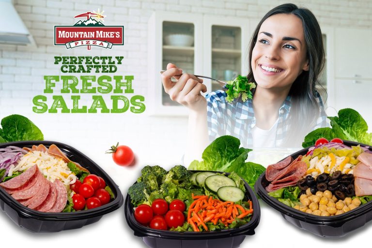 Picture of three salads with a person eating one of them.