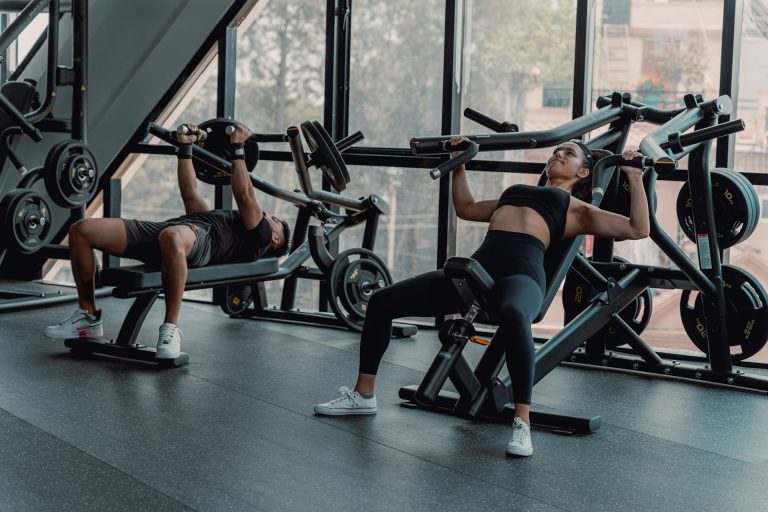 Image of both a male and female working out at golds gym.