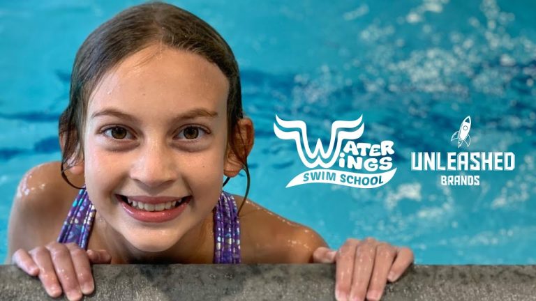 Water Wings Swim School image of young child with goggles in pool.