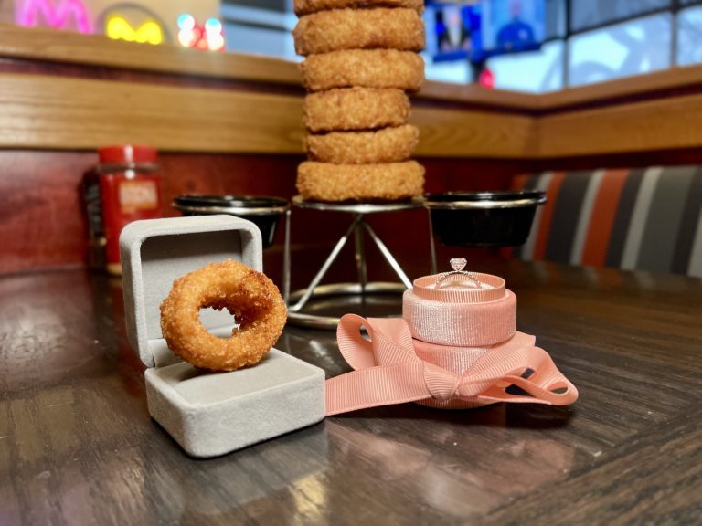 Onion ring in engagement ring box at a red robin location.