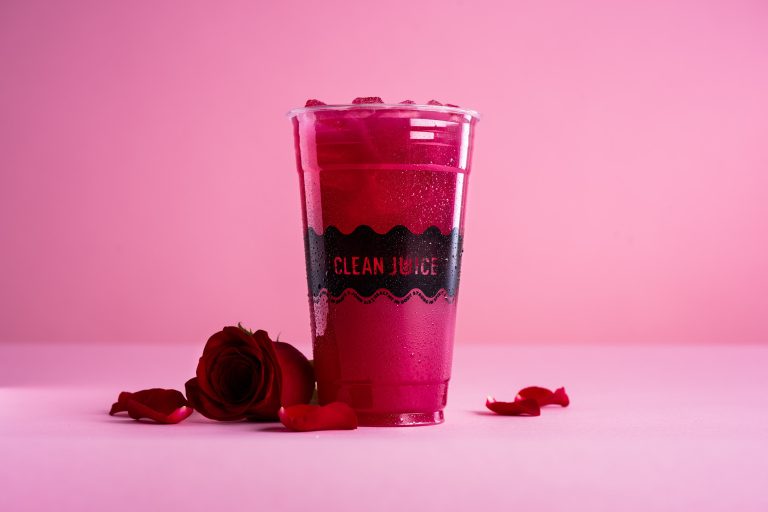 Image of The Rosey & Bright One - Rose Water based drink that is red in color.