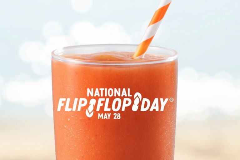 Image of Mango centric smoothie that is orange with straw