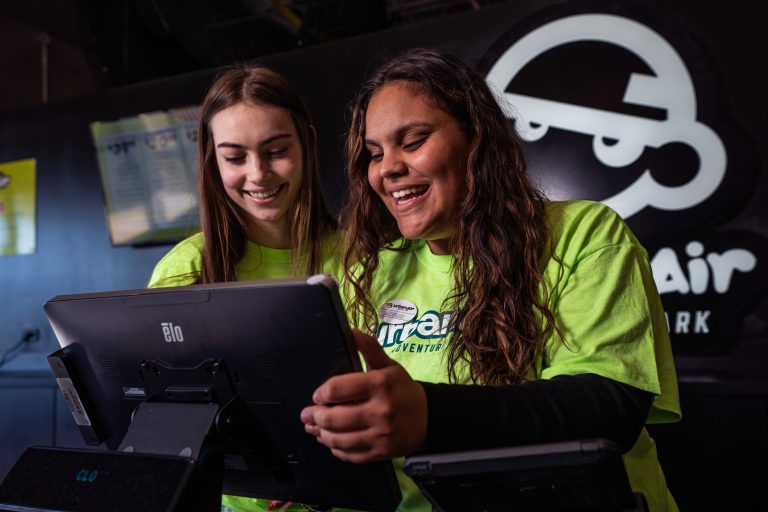 Urban Air Adventure Parks Team members to people at point of sale system representing Gen Z employees