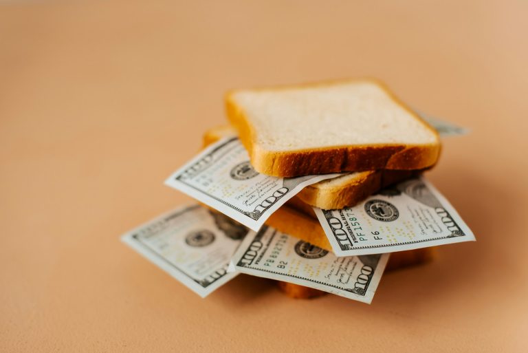 Franchise Incentives represented by A stack of money on top of a slice of bread.