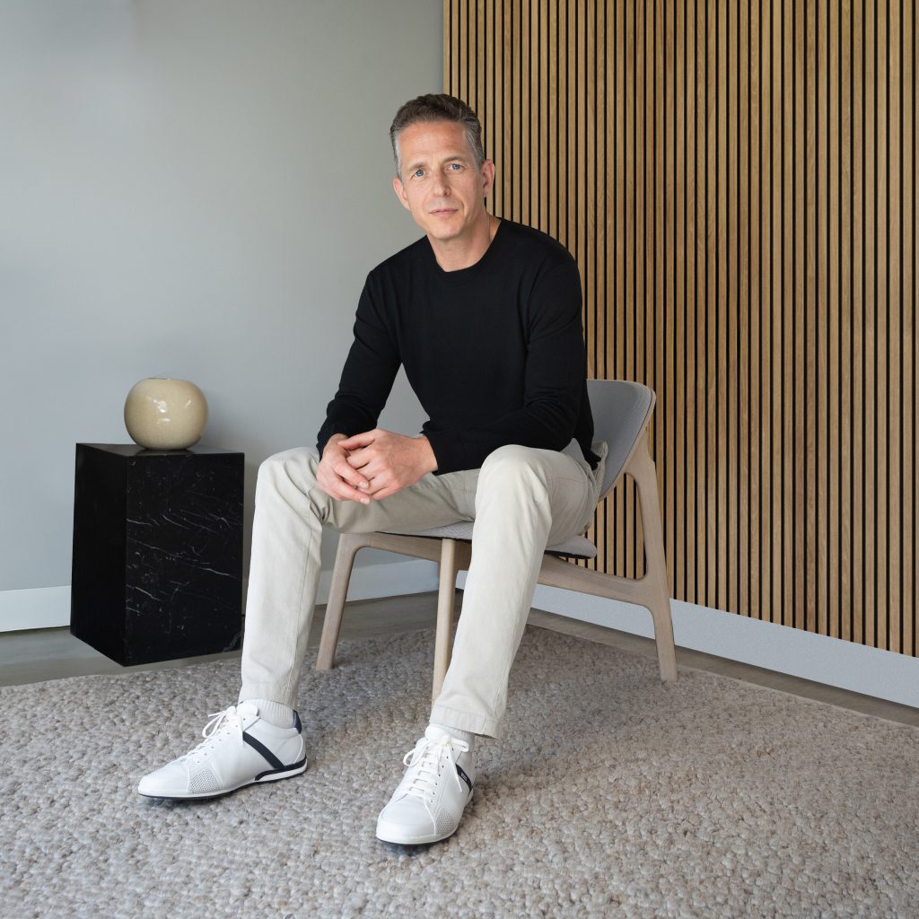 Phil Andreopoulos Headshot - person seated on chair