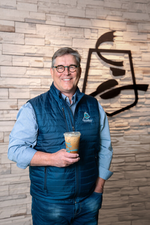 CEO holding iced coffee